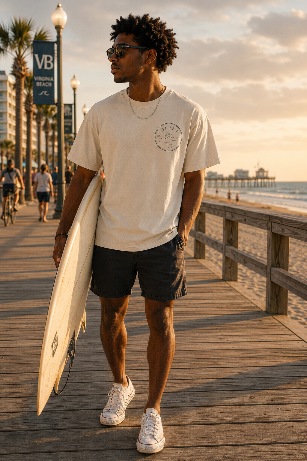 Model on the Virginia Beach boardwalk wearing a Drift Collective tee with the front chest logo