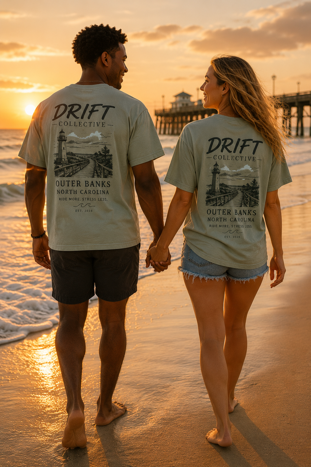 Couple walking at sunset on the shoreline wearing Drift Collective Outer Banks tees